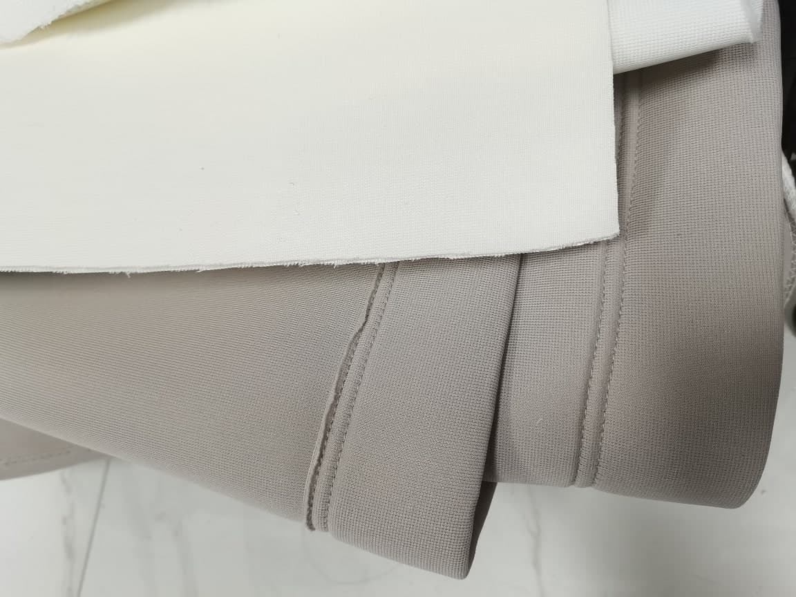 Premium white cloth laid over premium grey, both with the same folded and stitched edge